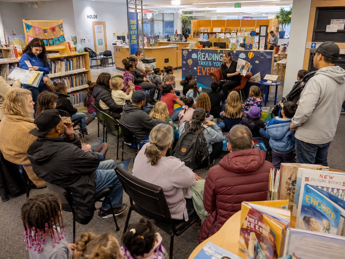 Families and children gathered for a reading program at a public library